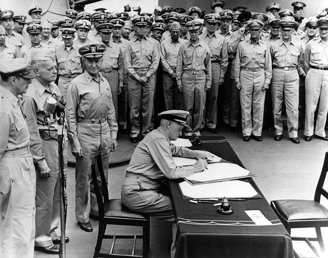 Admiral Chester Nimitz signs as Supreme Allied Commander during formal