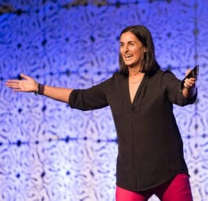 Shereen Kassam presenting to a large audience